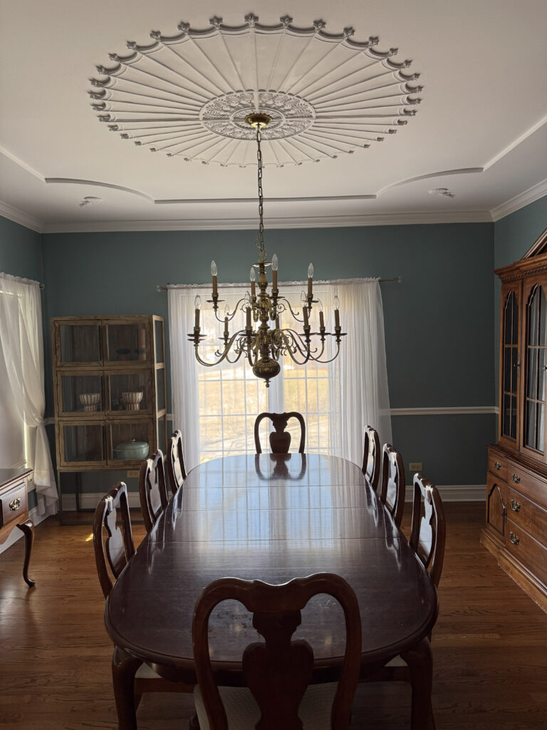 Dining room with ornate ceiling and blue walls